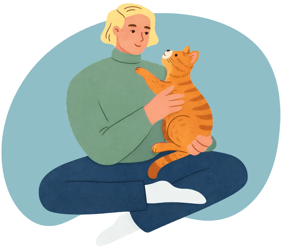 Une fille assise sur le sol tient tendrement un chat roux dans ses bras.